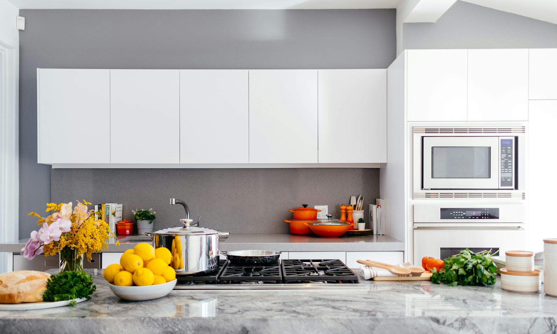 A kitchen with an oven, microwave, and cooktop